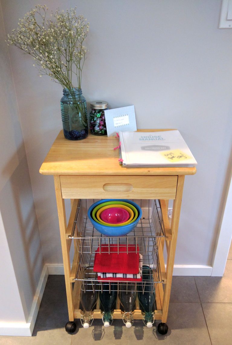Cute kitchen cart with wire baskets and a house manual