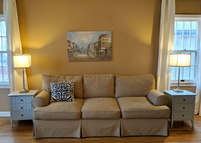 a relaxing living room with a pastel painting of Paris