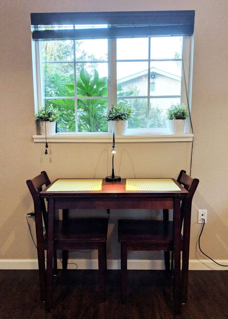 tiny table in front of window with two chairs