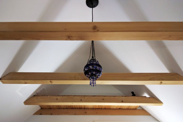 looking up at a ceiling with exposed beams